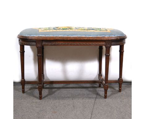 A late 19th Century walnut and beech stool, oval top, turned and fluted legs, the top 94x38cm, height 57cm.