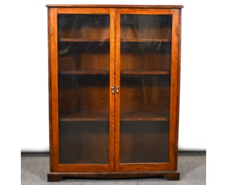 Oak bookcase, rectangular top with moulded edge, two glaze doors enclosing three adjustable shelves, bracket feet, width 92cm