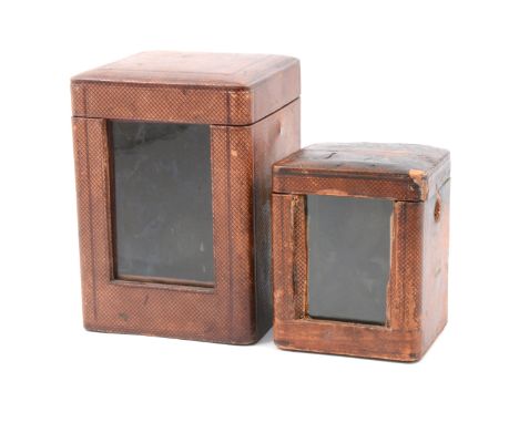 Two carriage clock travelling cases, both with glass window and cover, the larger bearing the name Penlington &amp; Batty, Ma