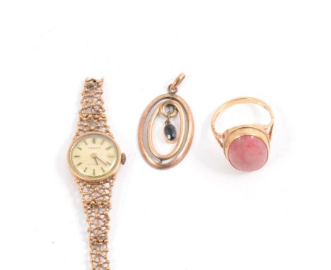 A 9 carat yellow gold dress ring set with an oval cabochon cut pink stone, ring size P, gross weight 5.2gm, lady's 9 carat ye