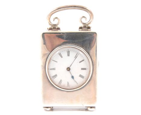 Silver cased carriage clock timepiece, scrolled handle, ball feet, circular enamelled dial, the movement stamped JTC for the 