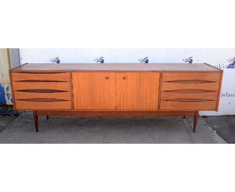 JOHN HERBERT( BRITISH, FLOR. 1950's-1960's) FOR YOUNGER, a teak rectangular sideboard, with two central cupboard doors, enclo