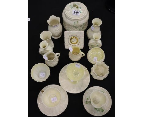 Belleek; eighteen pieces, cups, saucers, biscuit barrel, clock, vases, jugs, bowls with green and some black. Not available f