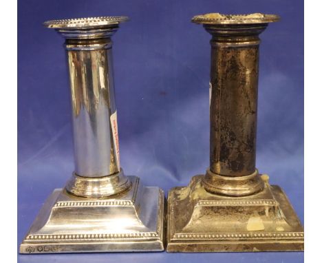 A pair of hallmarked silver weighted stub candlesticks by Elkington &amp; Co. Sheffield assay, H: 13 cm. One polished, one no