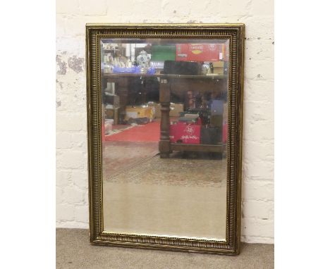 A gilt framed bevel edge wall mirror.