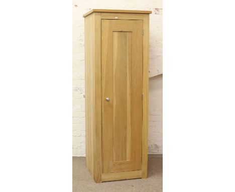 A good quality solid light oak and panelled single wardrobe with two internal shelves and hangers.