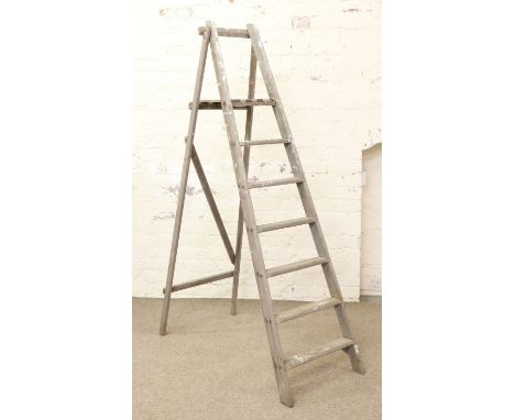 A wooden folding step ladder.