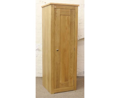 A good quality solid light oak and panelled single wardrobe with two internal shelves and hangers.