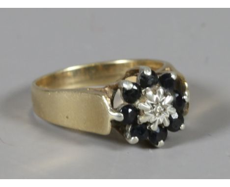 A 9ct gold, diamond and sapphire cluster ring, size M