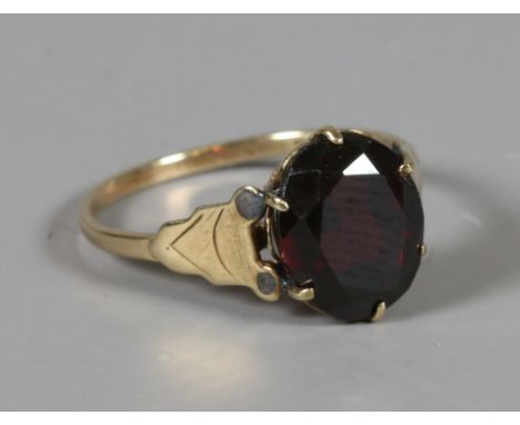 A 9 carat gold single stone garnet ring. Size K 1/2.