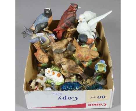 A collection of ceramic models of birds along with a Wade Disney figure.