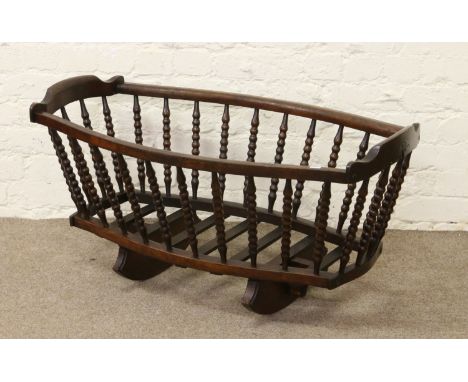 An oak bobbin turned cradle.