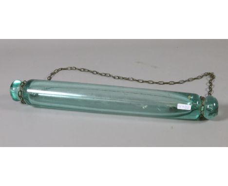 A Victorian hand blown glass rolling pin containing a silver six pence. 