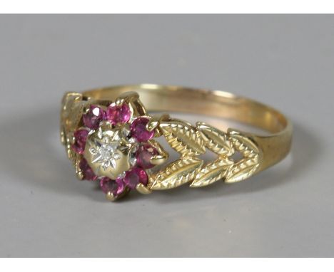 A 9ct gold ruby and diamond cluster ring with pierced foliate shoulders UK size Q