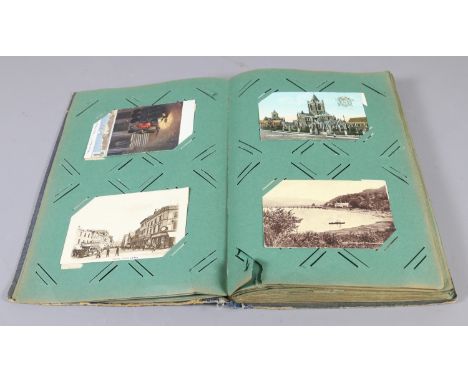 A postcard album and contents of postcards to include monochrome and coloured examples.