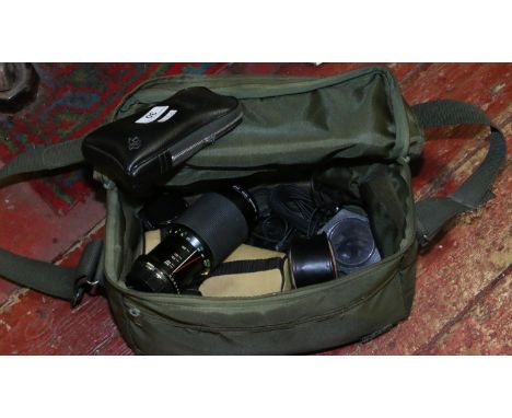 A camera carry bag and contents of lenses and accessories.