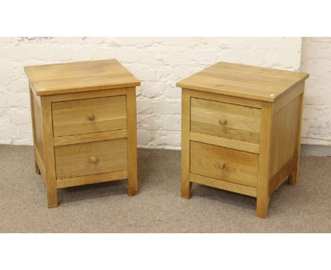 A pair of good quality solid light oak bed side chest of two drawers.