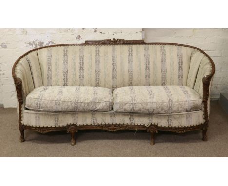 A French carved walnut sofa.