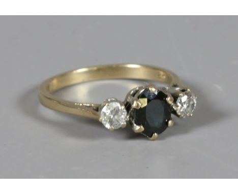 A 9 carat gold trilogy ring set with a sapphire flanked by two diamonds 0.1ct each. Size M. Condition Report. To be used as a