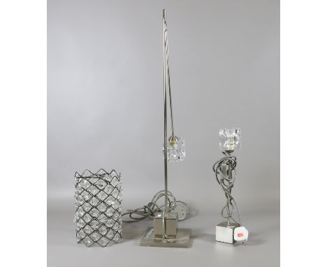 A slender chrome standard lamp, matcing table lamp and glass droplet light shade.