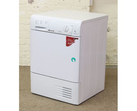 A Hotpoint Aquarius 8kg tumble dryer model No. TCM580 in white enamel with instruction manual.