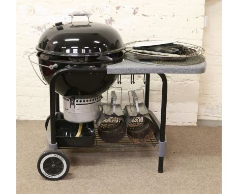 A Weber one touch platinum tubular steel and enamel barbeque on wheeled stand with galvonized work area along with cover, gri