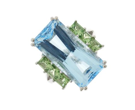 An 18ct gold blue topaz single-stone dress ring, with square-shape green tsavorite garnet line sides and tapered band, topaz 