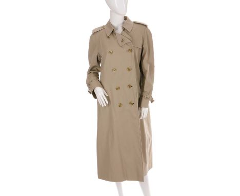 Burberry, a ladies trench coat, featuring double breasted front button fastenings, buttoned epaulettes and the makers classic