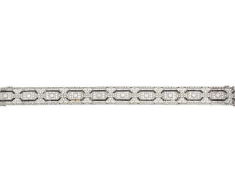 A mid 20th century platinum, vari-cut diamond and onyx bracelet, of openwork geometric design, with partially concealed push-