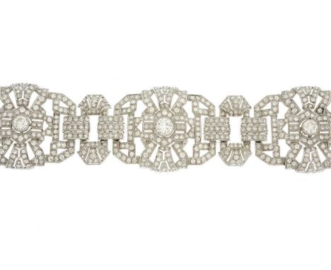An impressive mid 20th century platinum, circular-cut diamond bracelet, of openwork geometric design, with sliding clasp, est