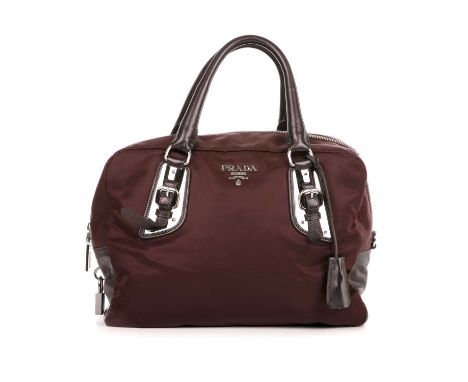 Prada, a nylon Boston bag, designed with a plum nylon exterior and dark metallic plum leather top handles and trim, with poli