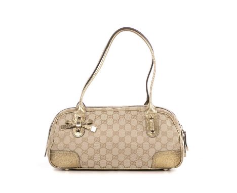 Gucci, a Princy Boston bag, featuring a beige GG canvas exterior with metallic gold leather trim and bow detail, dual thin le