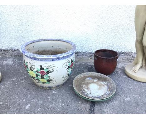 A large ceramic planter, with blue and white decorated rim above a polychrome floral decorated body (33cm x 45cm), a blue and
