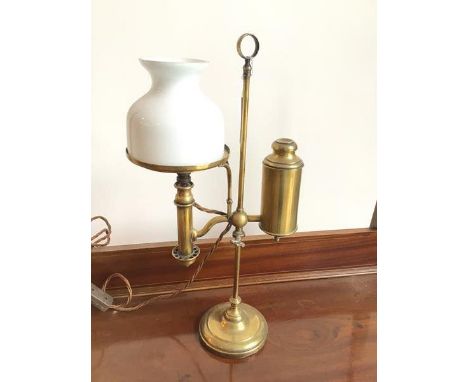 A c.1900 student's oil lamp, with milk glass shade and gas cannister to one side, on circular base, later converted for elect
