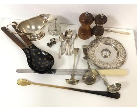 A mixed lot including a white metal candlestick, a bone handled carving knife and stirring spoon, Epns ladles, spoons, sauceb