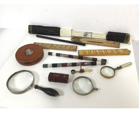 A collection of rulers, including, AW Faber, made in Bavaria, Lufkin Rule Co. tape measure, magnifying glasses, thermometer (