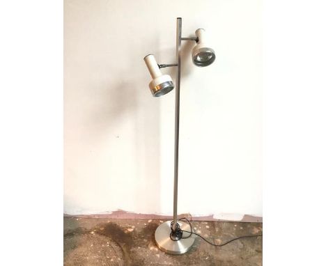 A modern metal standard lamp, the square stem with two arms, each with adjustable lamp with individual switches, on circular 