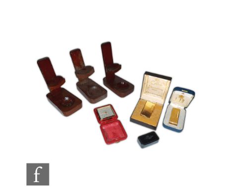 A Looping eight day bedside clock, a Dunhill and Calibri  cigarette lighters, both boxed, a snuff box and a collection of woo