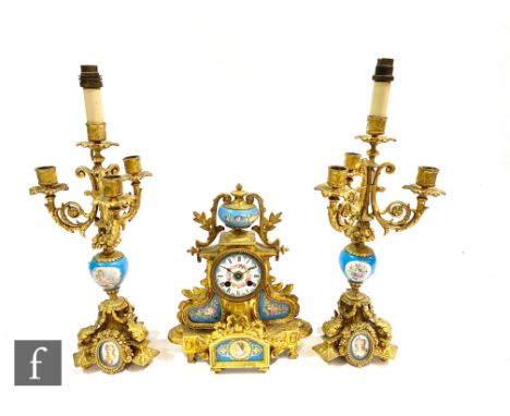 A 19th Century gilt metal and Sevres style panel eight day strike mantle clock garniture, Roman numerals to foliate decorated