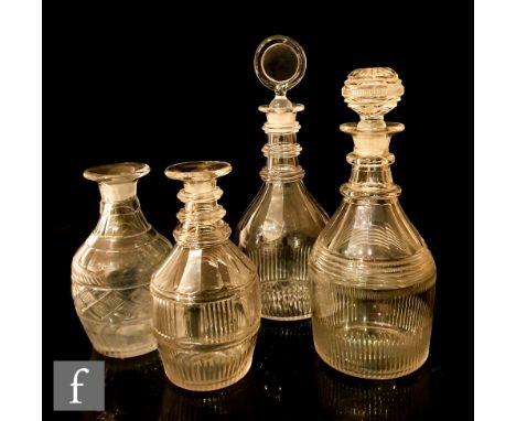 An early 19th Century clear crystal decanter of Prussian form with pillar, slice and mitre cut decoration beneath a two ring 