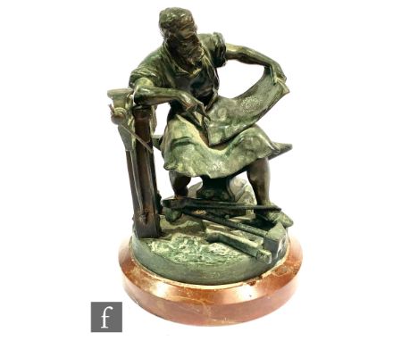 A late 19th Century bronze study by H Guradze of a medieval Black Smith or leather worker working a parchment with pincers an