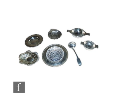 Seven items of hallmarked silver to include two small quaiche shaped bowls, a butter dish with glass liner, three pin dishes 
