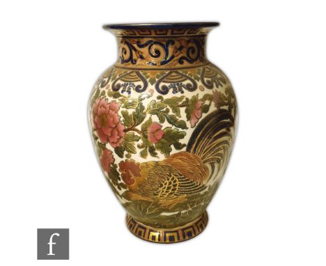 A large early 20th Century Zsolnay Pecs vase decorated with a cockerel amidst pink flowers and foliage with a blue and gilt r