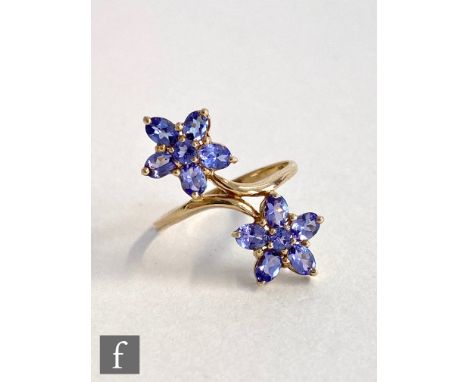 A 9ct hallmarked tanzanite ring, claw set stones to double flower head all to a plain shank, weight 2.9g, ring size S. 