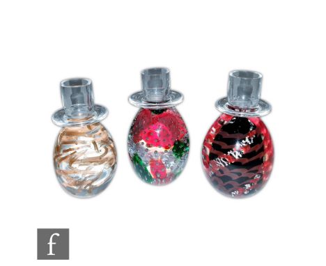 A set of three Venetian glass candlesticks by Vecchia Murano of ovoid form with flat rimmed sconce, each internally decorated