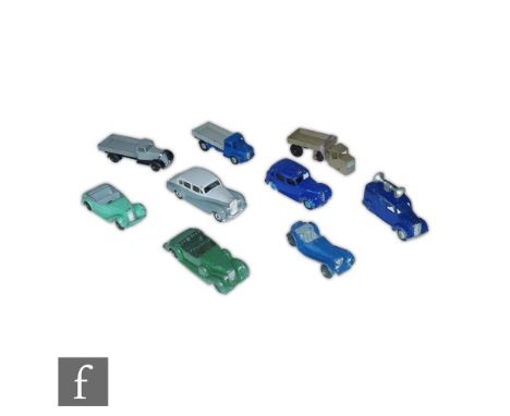 A collection of nine post war Dinky diecast models, commercial vehicles and cars to include Wagon with black chassis and grey