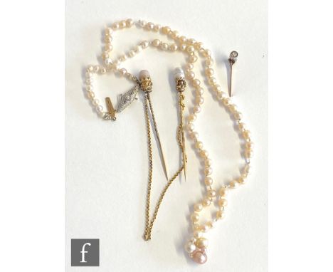 A single row of graduated fresh water pearls terminating in diamond set clasp, length 44cm, with a diamond set stick pin, and