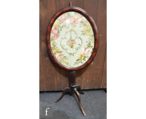 A Victorian pole screen, the oval framed panel with needlework floral study and with a tripod base, A/F. 
