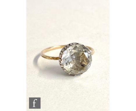 A 19th Century rock crystal single stone ring, claw set stone to a plain thin shank with cut detail to shoulders, weight 2g, 