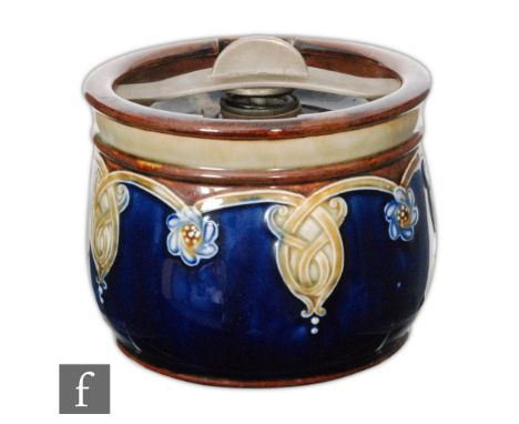 An early 20th Century Royal Doulton Lambeth stoneware tobacco jar and cover of cylindrical form, relief moulded with a band o
